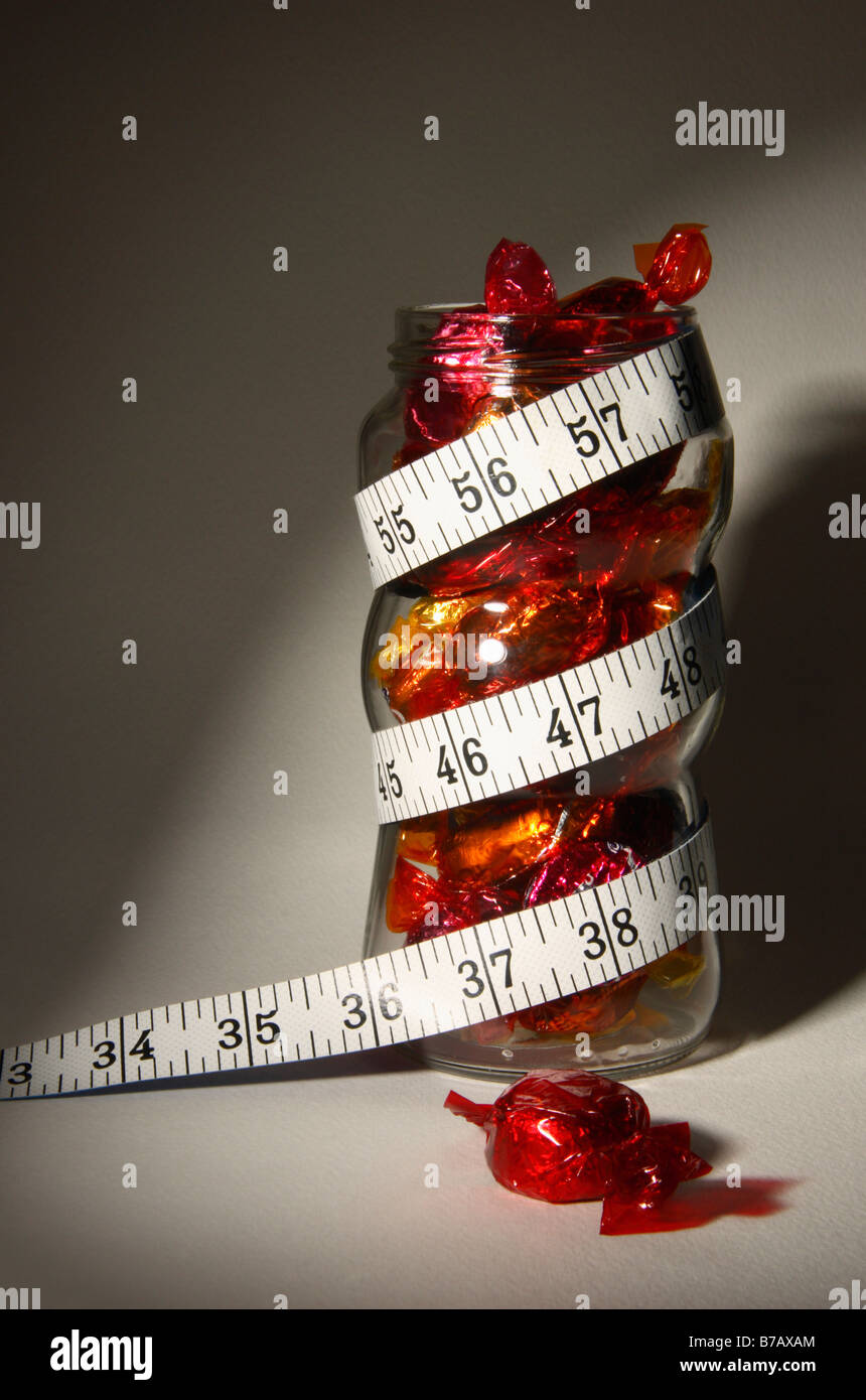 Chocolates in a jar. Overweight concept. Stock Photo