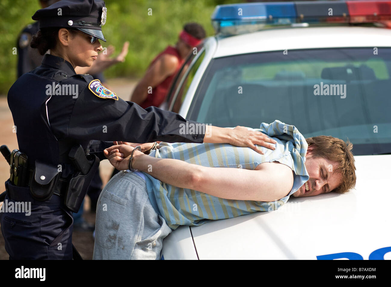 Police Officers Arresting Suspects Stock Photo