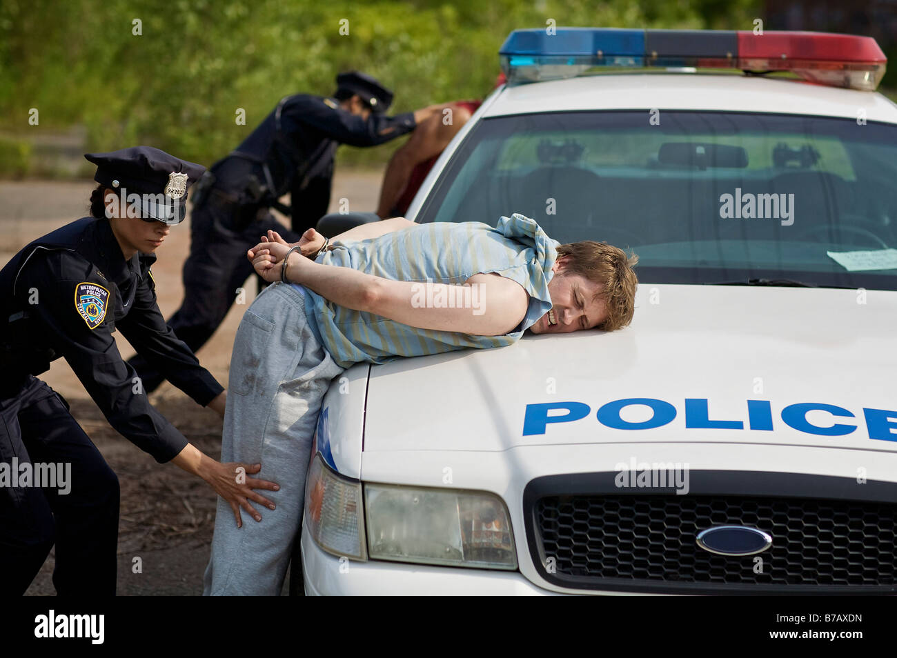 Police Officers Arresting Suspects Stock Photo
