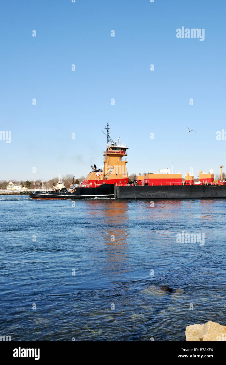 Tugboat pushing a fuel oil barge in the ocean Stock Photo