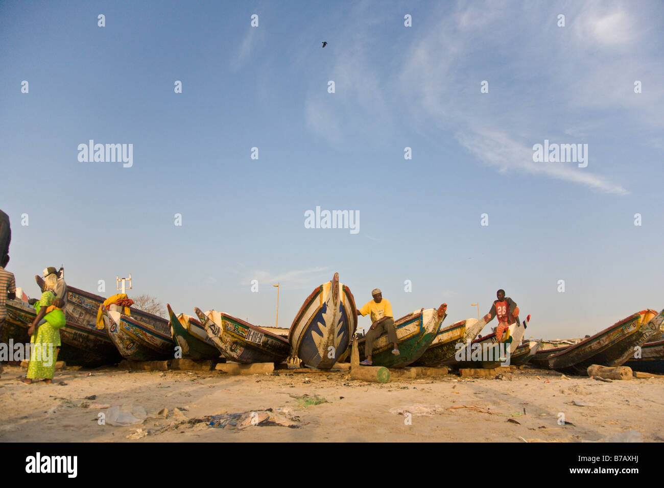 Colorfully painted fishing boats line the beach at this fish market in Dakar, Senegal. Stock Photo