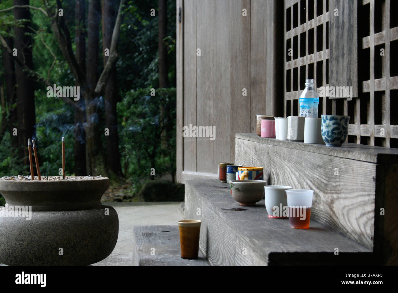 Cups of water by pot of burning incense at a Japanese temple, Kyoto