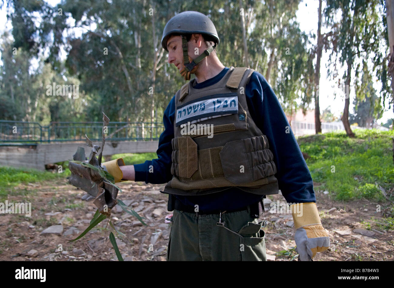 An Israeli police sapper carries the remains of a Kassam rocket fired from Gaza strip and landed in the southern town of Sderot. Israel Stock Photo