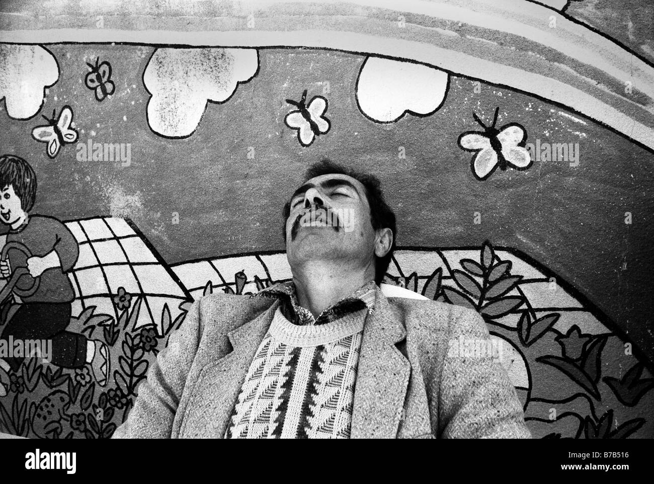 A Palestinian man sleeping in a local school playground in Samaria area West bank Israel Stock Photo