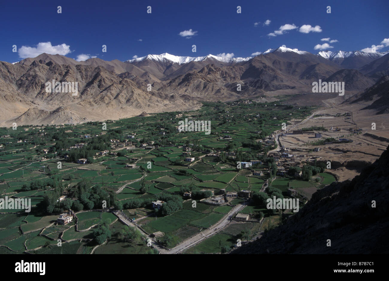 view over village fields in arid valley towards Sankar gompa from Namgyal Tsemo gompa Leh Ladakh Jammu and Kashmir India Stock Photo