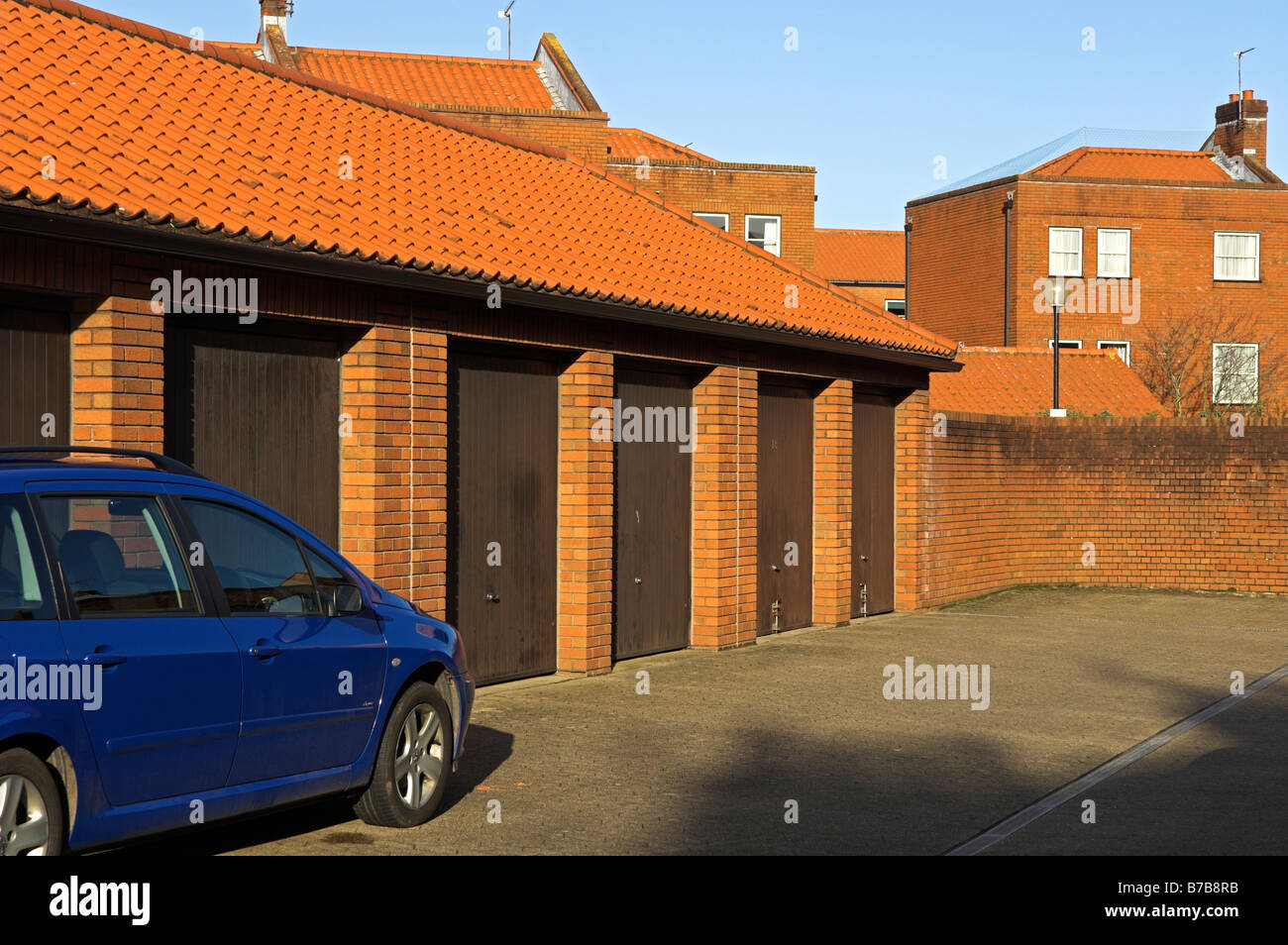 Rows of modern late 20th century garages in parking area behind new houses central Bristol England Stock Photo