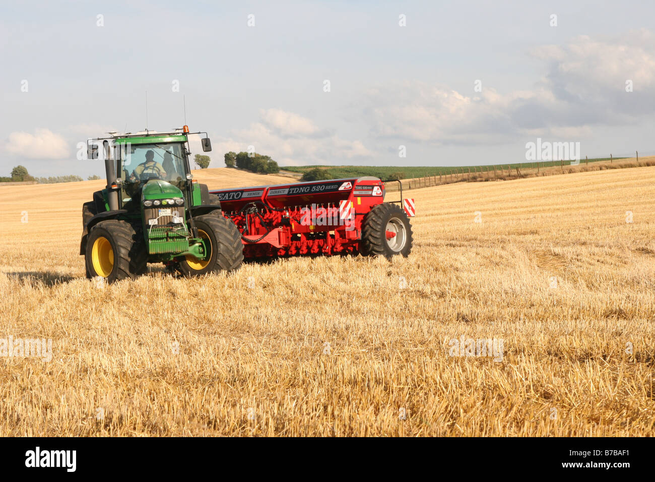 traktor with harrow on a harvested field, Germany, Mecklenburg-Western Pomerania Stock Photo