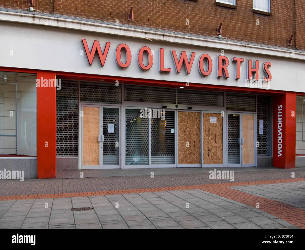 Closed down Woolworths High Street store boarded up and vandalised in Regent Street, Swindon UK Stock Photo