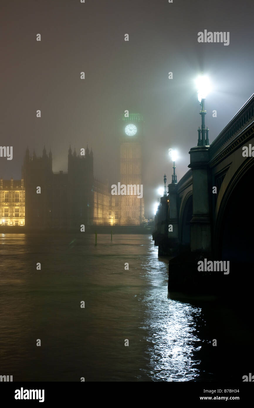 Houses of parliament and Westminster bridge on a foggy winter night. London, England, UK Stock Photo