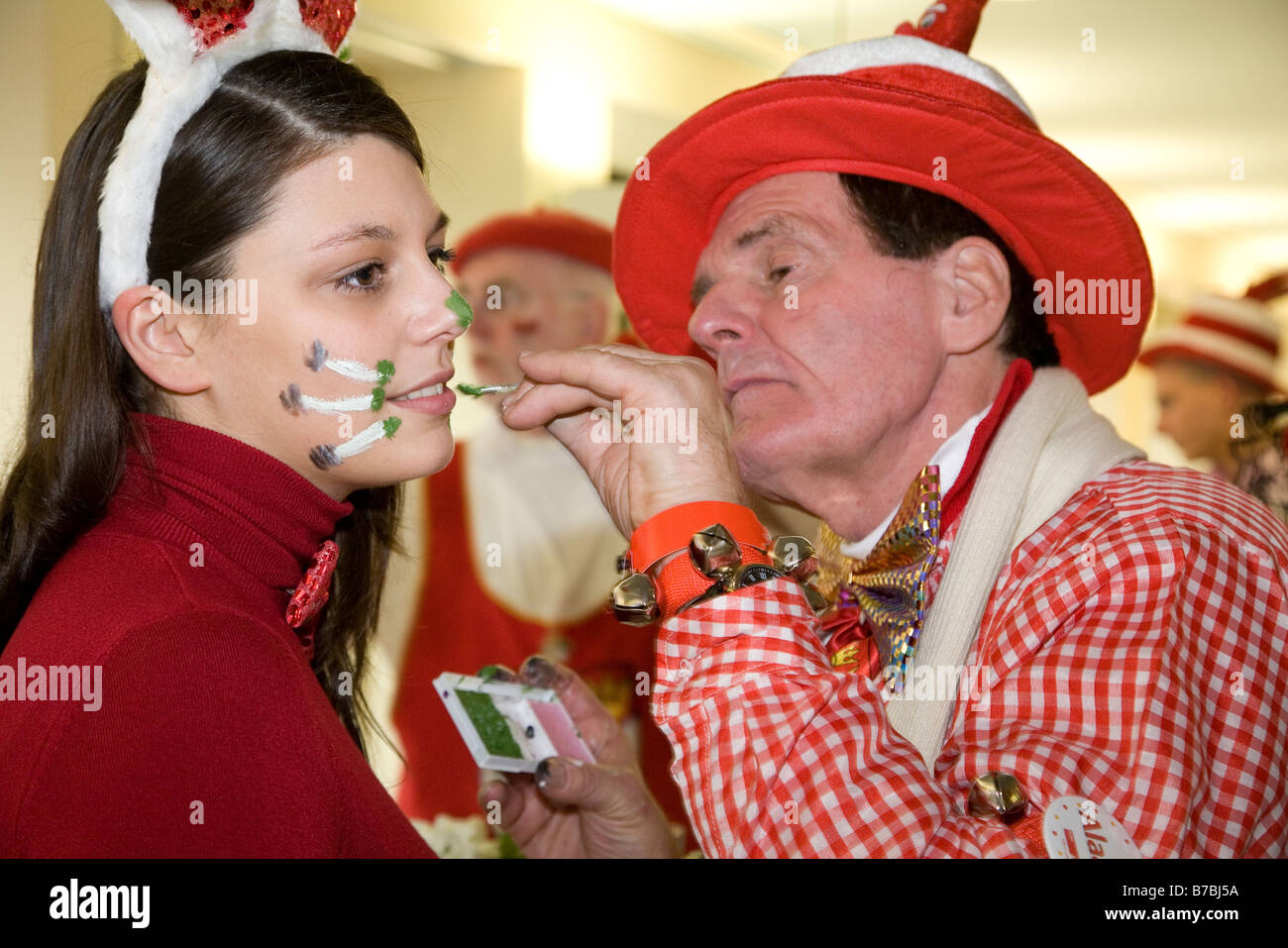 Carnival visitor having her face painted in costume Cologne, Köln Germany Stock Photo