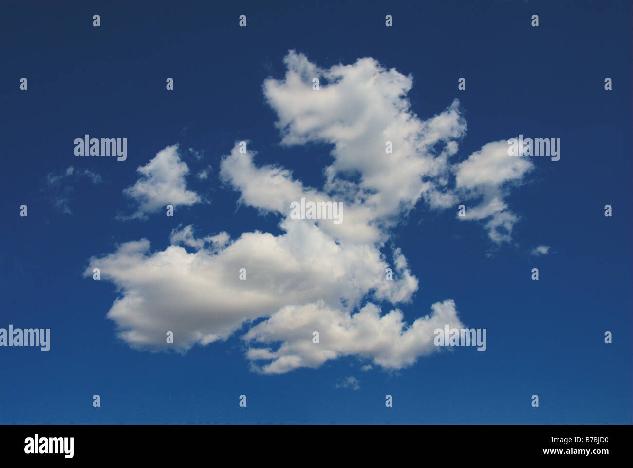Fluffy white cloud against a bright blue sky Stock Photo
