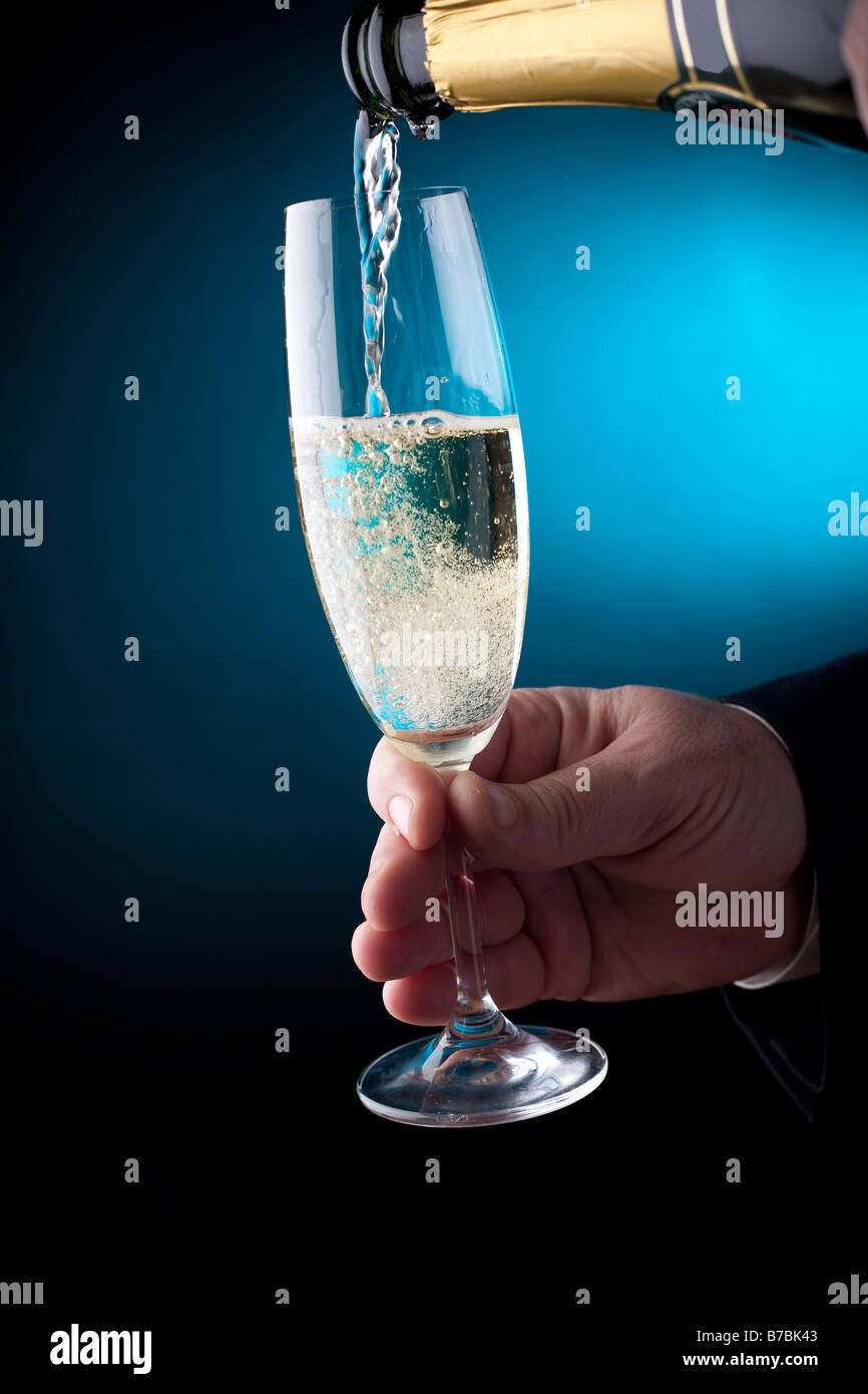 Hand holding a glass of champagne Stock Photo
