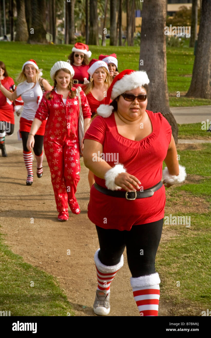Group of women in “Mrs. Santa Claus” outfits marching in Los Angeles Stock Photo