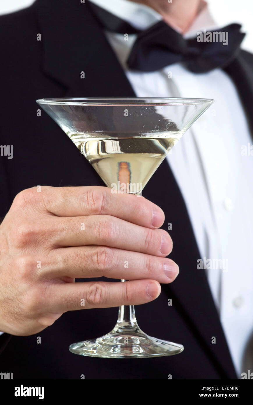 A close up of a man s hand who is dressed in formal attire and holding a  martini glass Stock Photo - Alamy