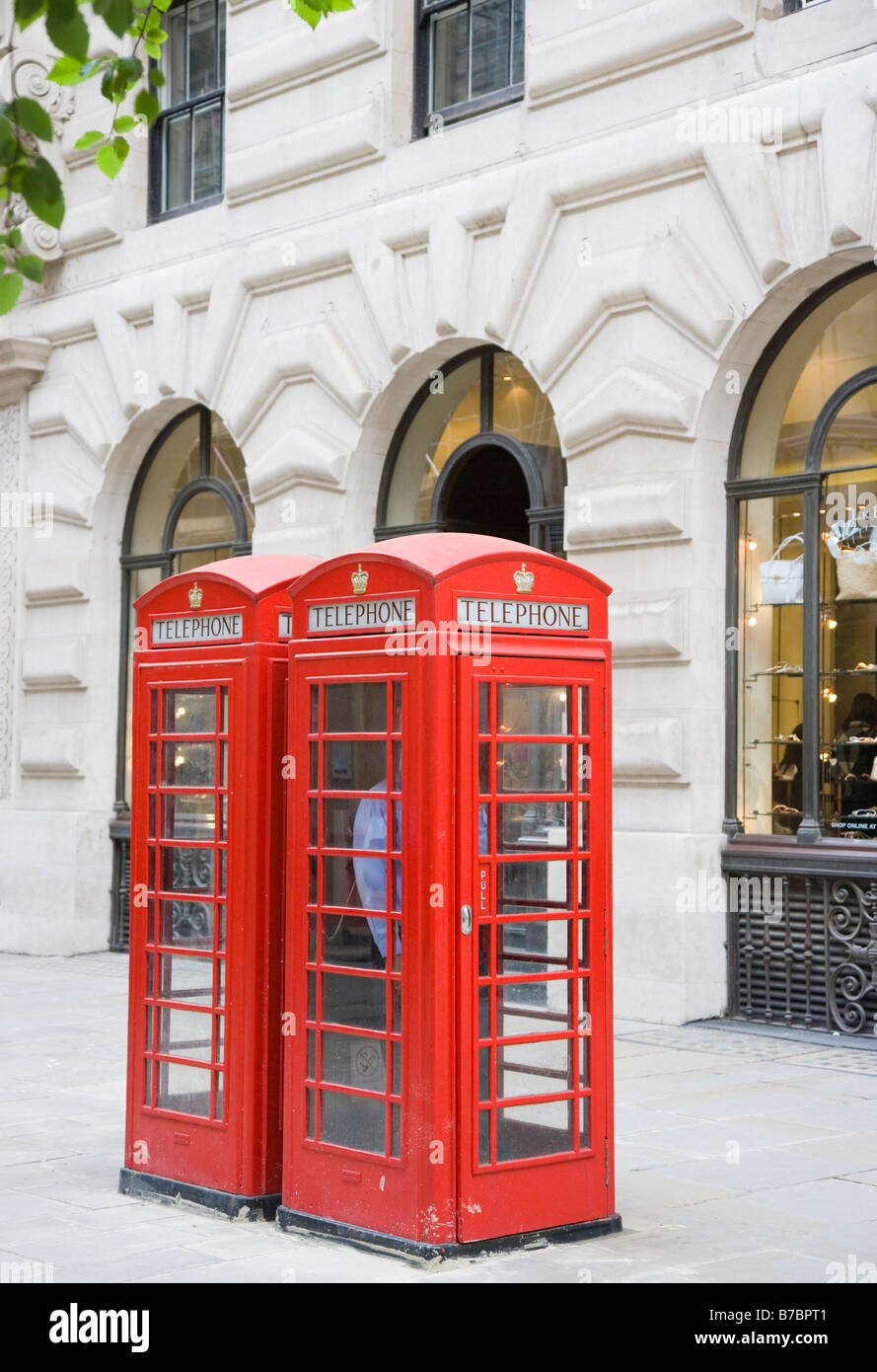 Two red old fashioned telephone boxes London England Stock Photo