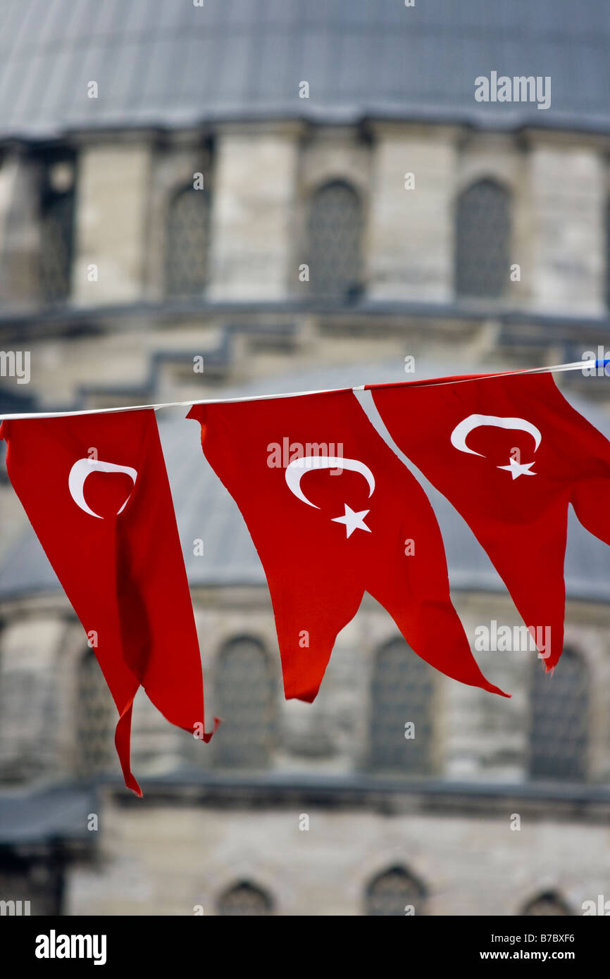 Turkish National Flags in front of Yeni Camii or the New Mosque in Istanbul Turkey Stock Photo