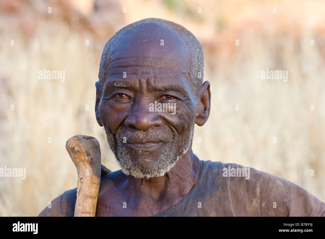 Elderly Dogon Man with a Small Ax in Youga Na in Pays Dogon in Mali Stock Photo