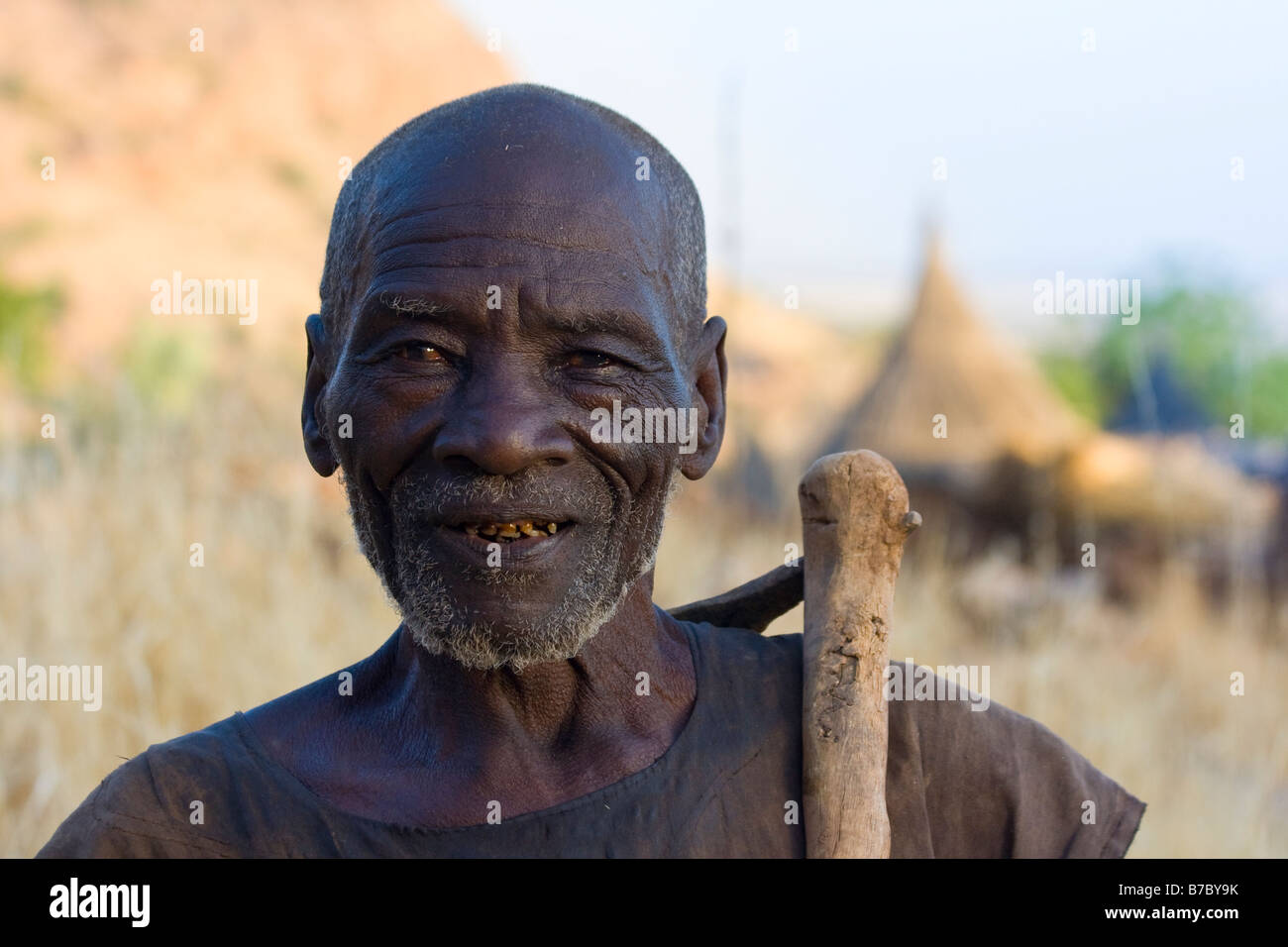 Elderly Dogon Man with a Small Ax in Youga Na in Pays Dogon in Mali Stock Photo