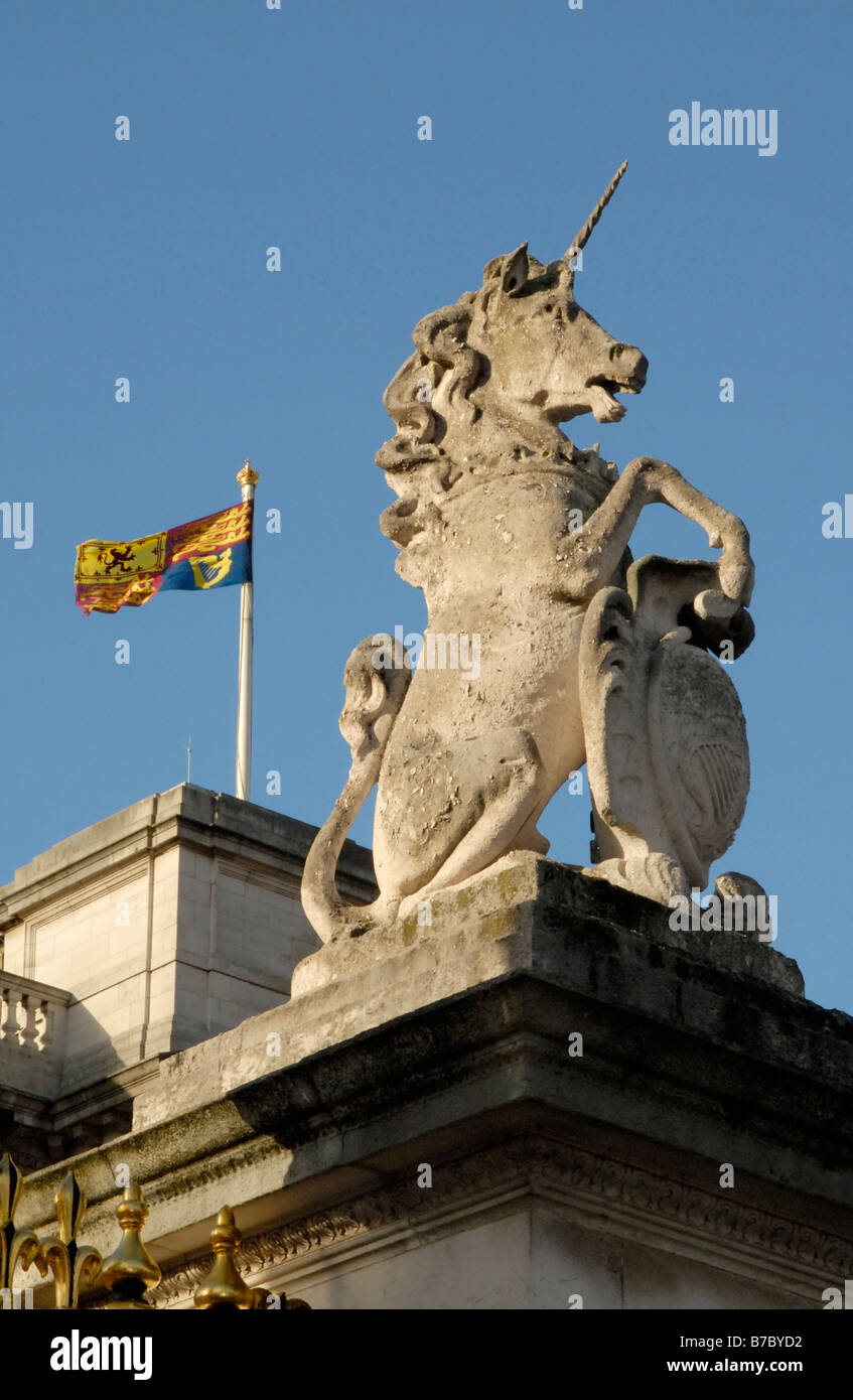 Unicorn on top of gate at Buckingham Palace with Royal Standard flying behind, Westminster, London, England Stock Photo