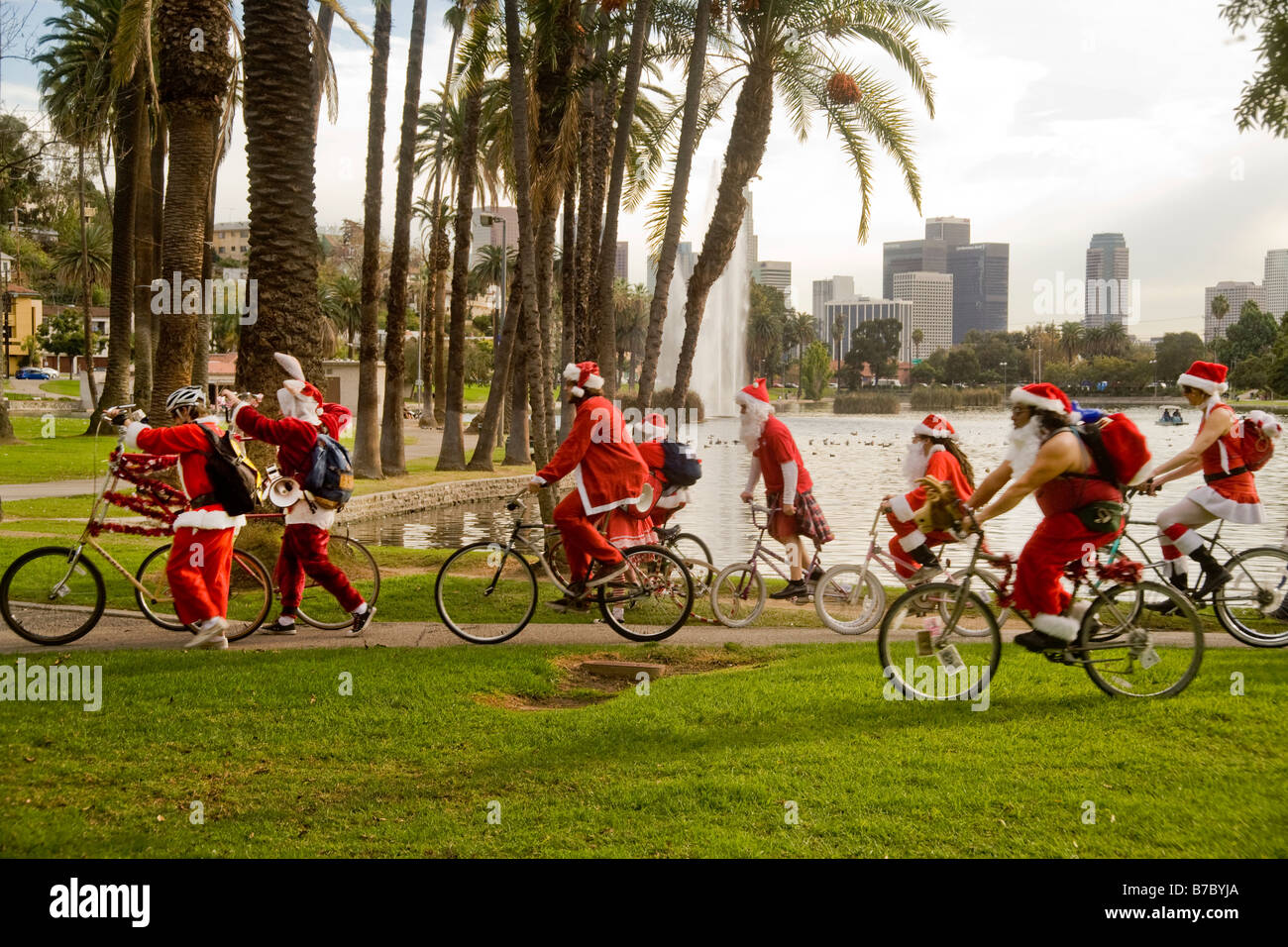 People in Santa Claus costumes bicycling in Los Angeles Stock Photo