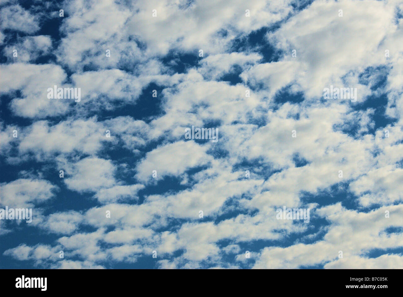 Fluffy white clouds against a bright blue sky Stock Photo