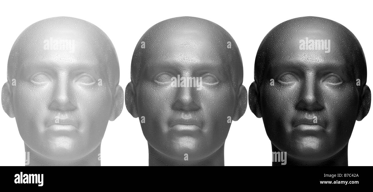 Three mannequin heads in white black and grey isolated against a white