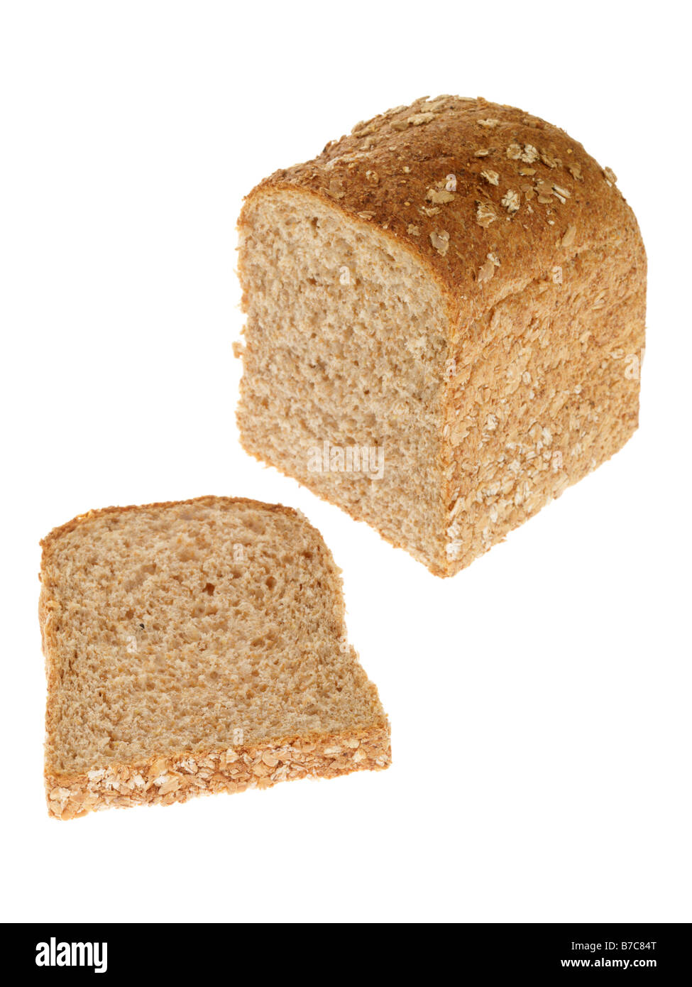 Loaf Of Brown Wholegrain Organic Bread Against A White Background With No People With Copy Space and a Clipping Path Stock Photo