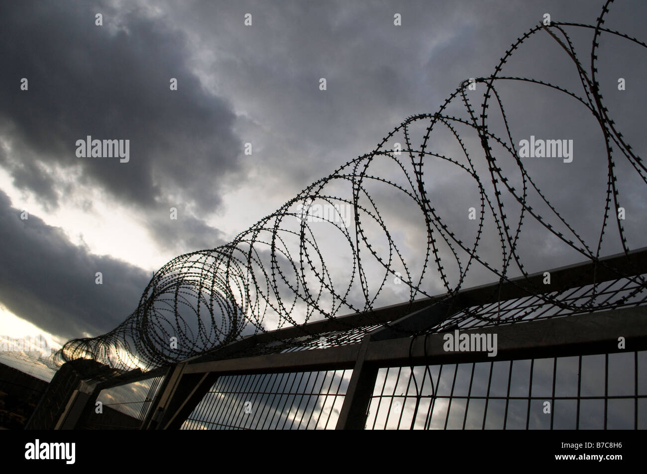 Coiled barbed wire fence between Northern Gaza strip and Netiv Haasara Jewish settlement, Southern Israel Stock Photo