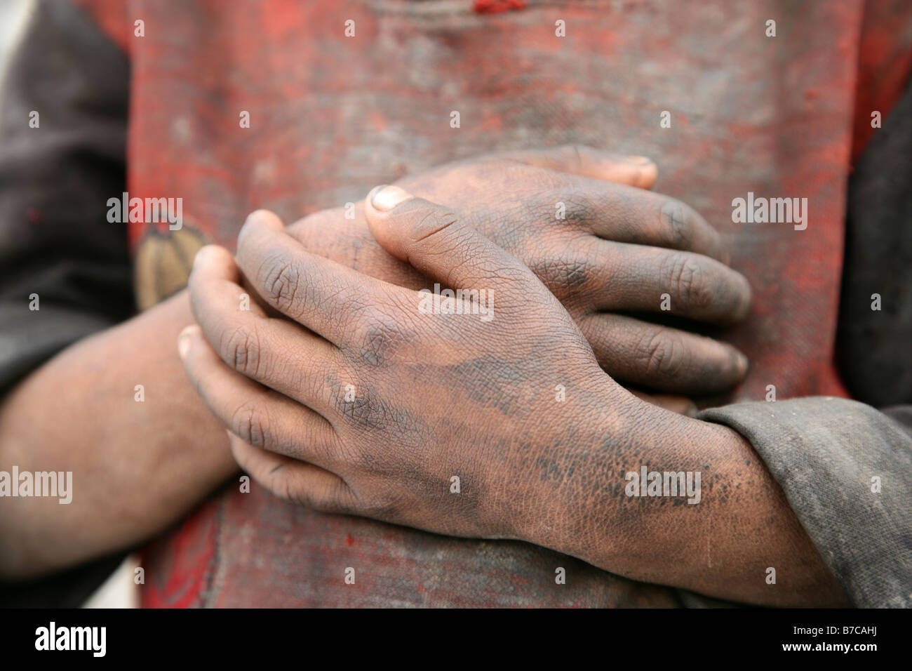Nepalese boy with filthy hands Stock Photo