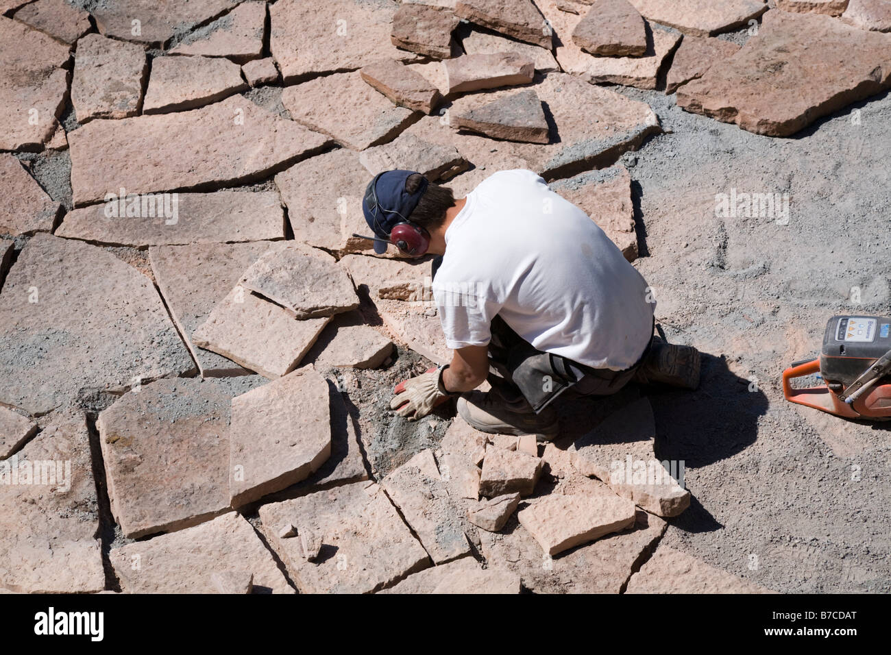 Man laying limestone slabs on a terrace Stock Photo Alamy