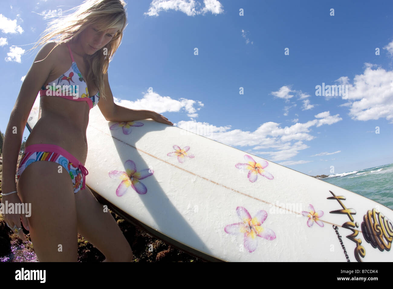 Surfer Girl on the beach Stock Photo