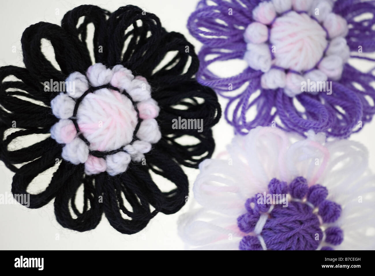 Knitted flowers produced by flower loom Stock Photo