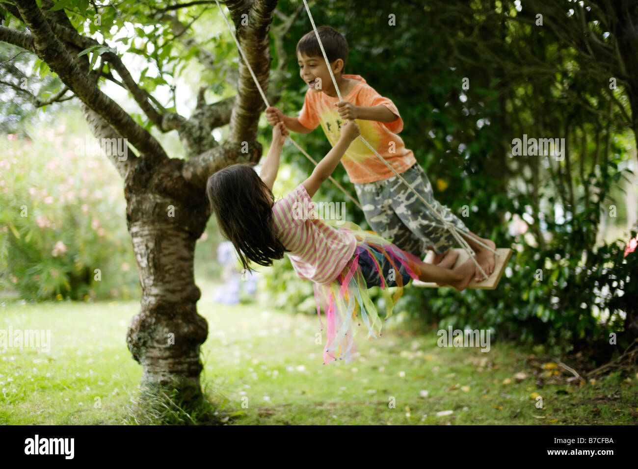 Brother And Sister On Swing Together Aged Six And Five Years Brother And Sister On Swing Together Aged Six And Five Years