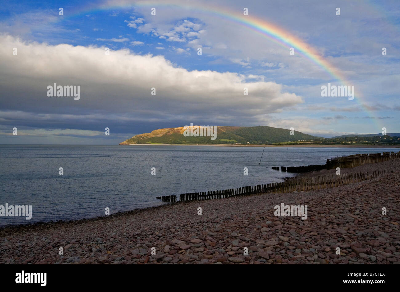 Rainbow and stormy sky on the beach at Porlock Weir near Minehead in Exmoor National Park North Somerset England UK Stock Photo