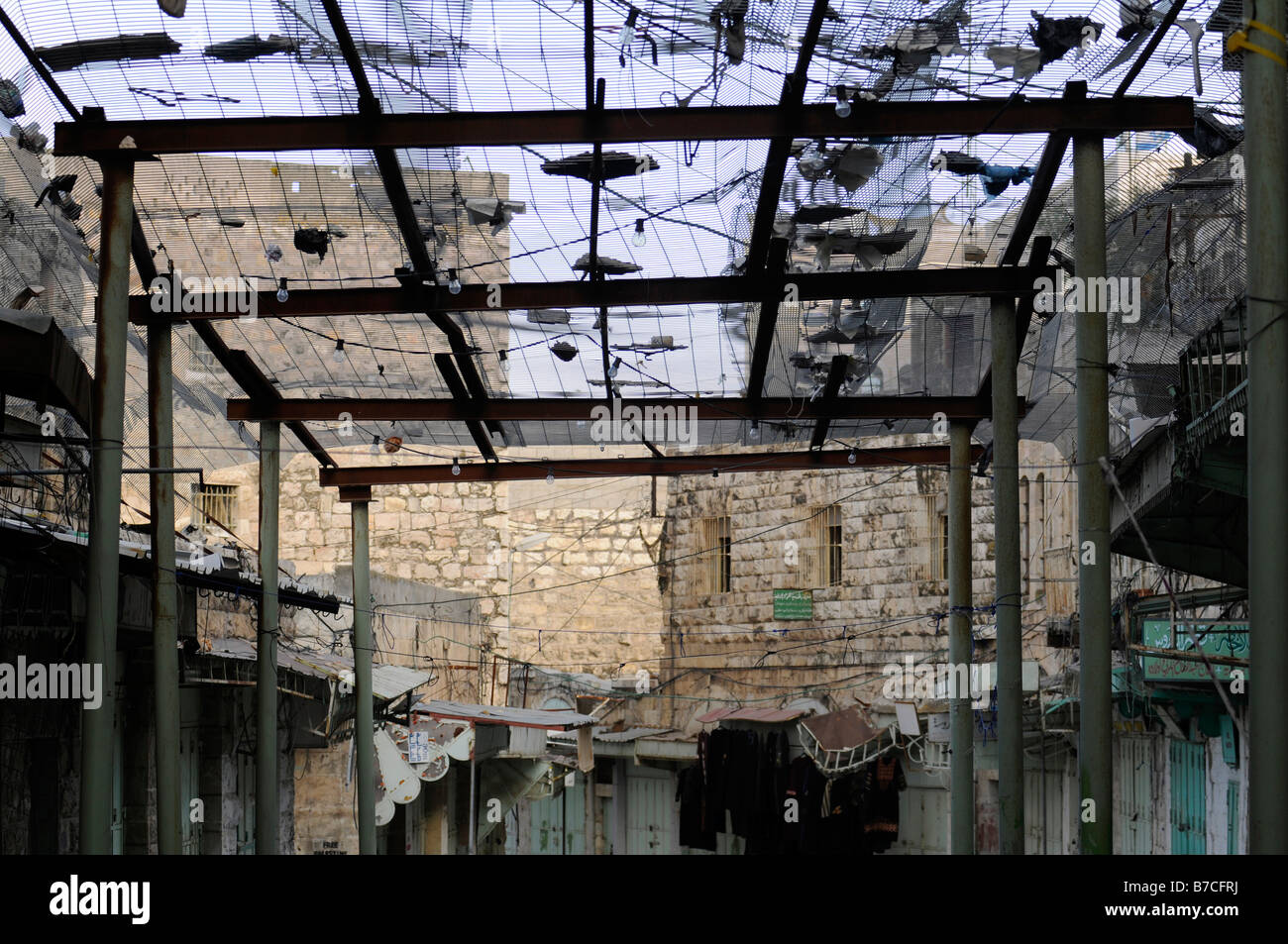 Street scene in  Hebron under Israeli occupation: a fence to protect Arab pedestrians from trashes thrown out by Jewish settlers Stock Photo