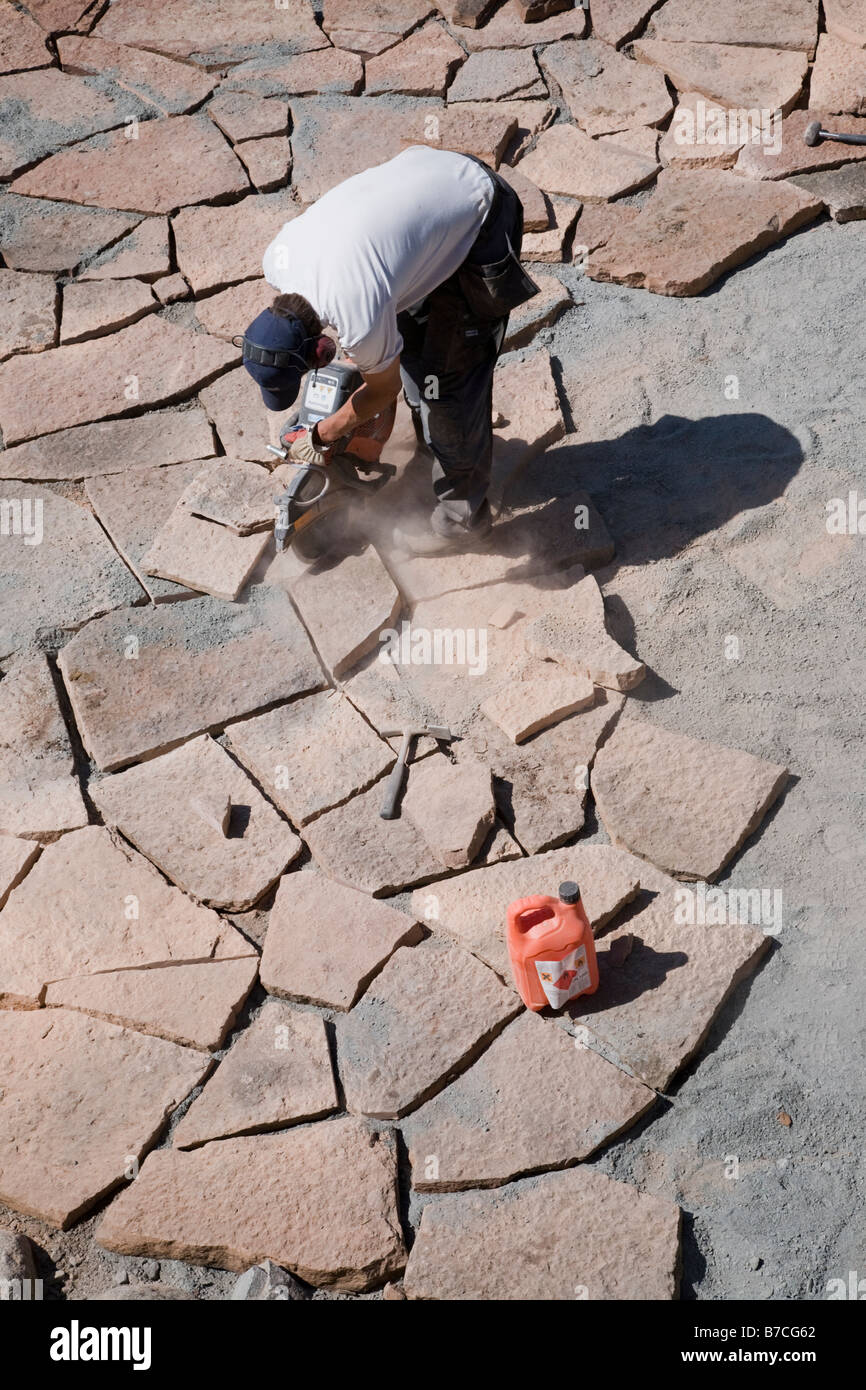 Man cutting and laying limestone slabs on a terrace Stock Photo Alamy