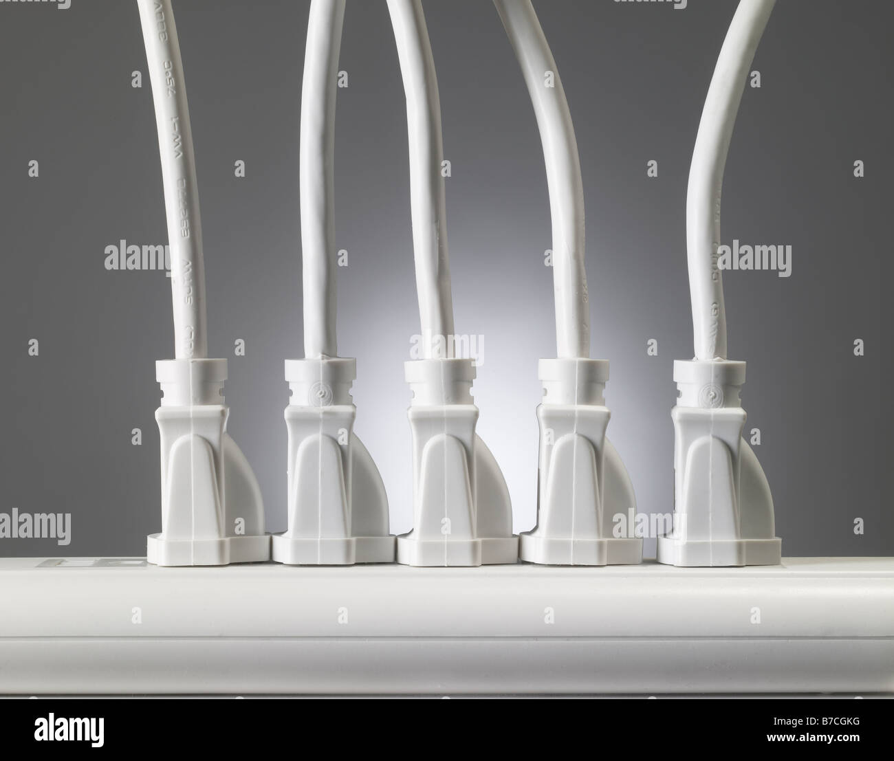 Many Electrical Cords Plugged In To Power Strip Stock Photo