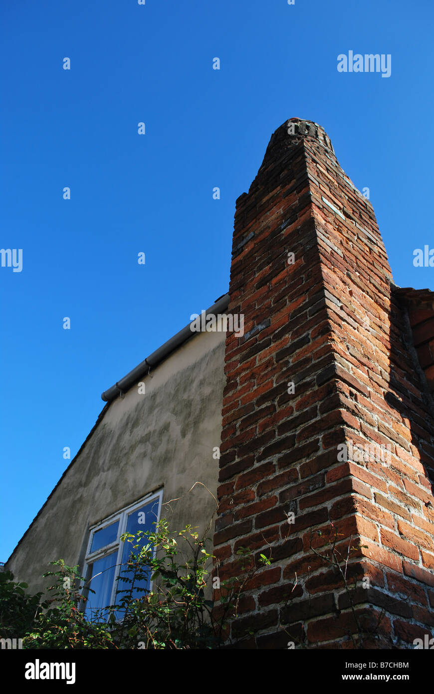 Tall chimney against a bright blue sky Stock Photo - Alamy