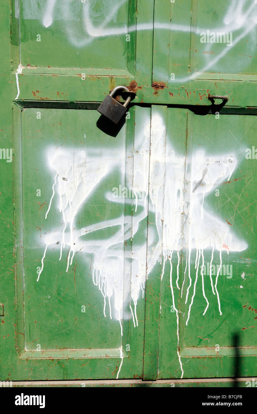 Street scene in Hebron under Israeli occupation: graffitis of David Star put by Jewish settlers on closed Arab shops. Stock Photo