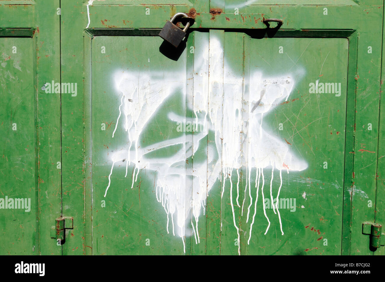 Street scene in Hebron under Israeli occupation: graffitis of David Star put by Jewish settlers on closed Arab shops. Stock Photo