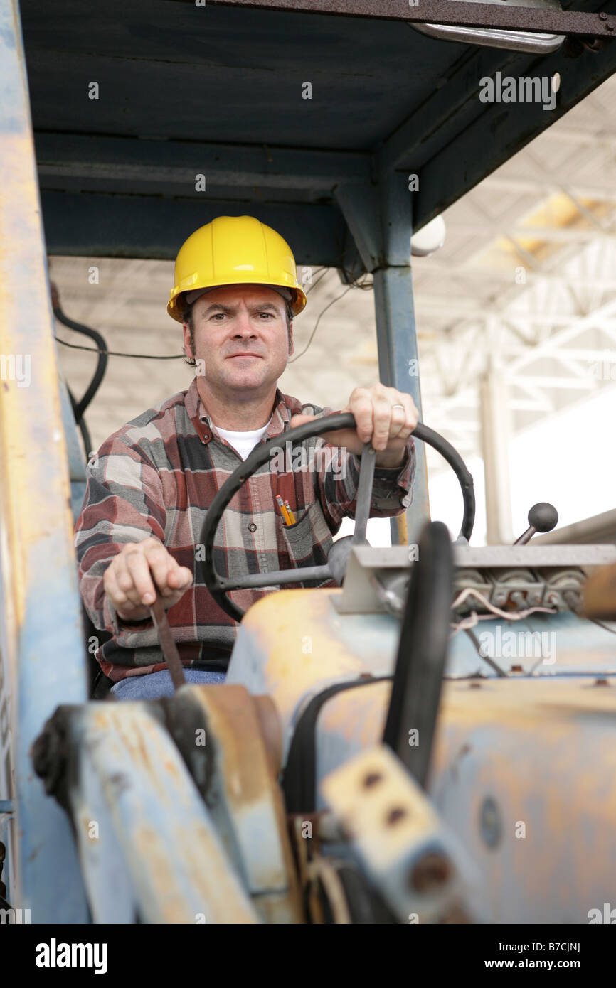 A heavy equipment operator driving a backhoe Stock Photo Alamy
