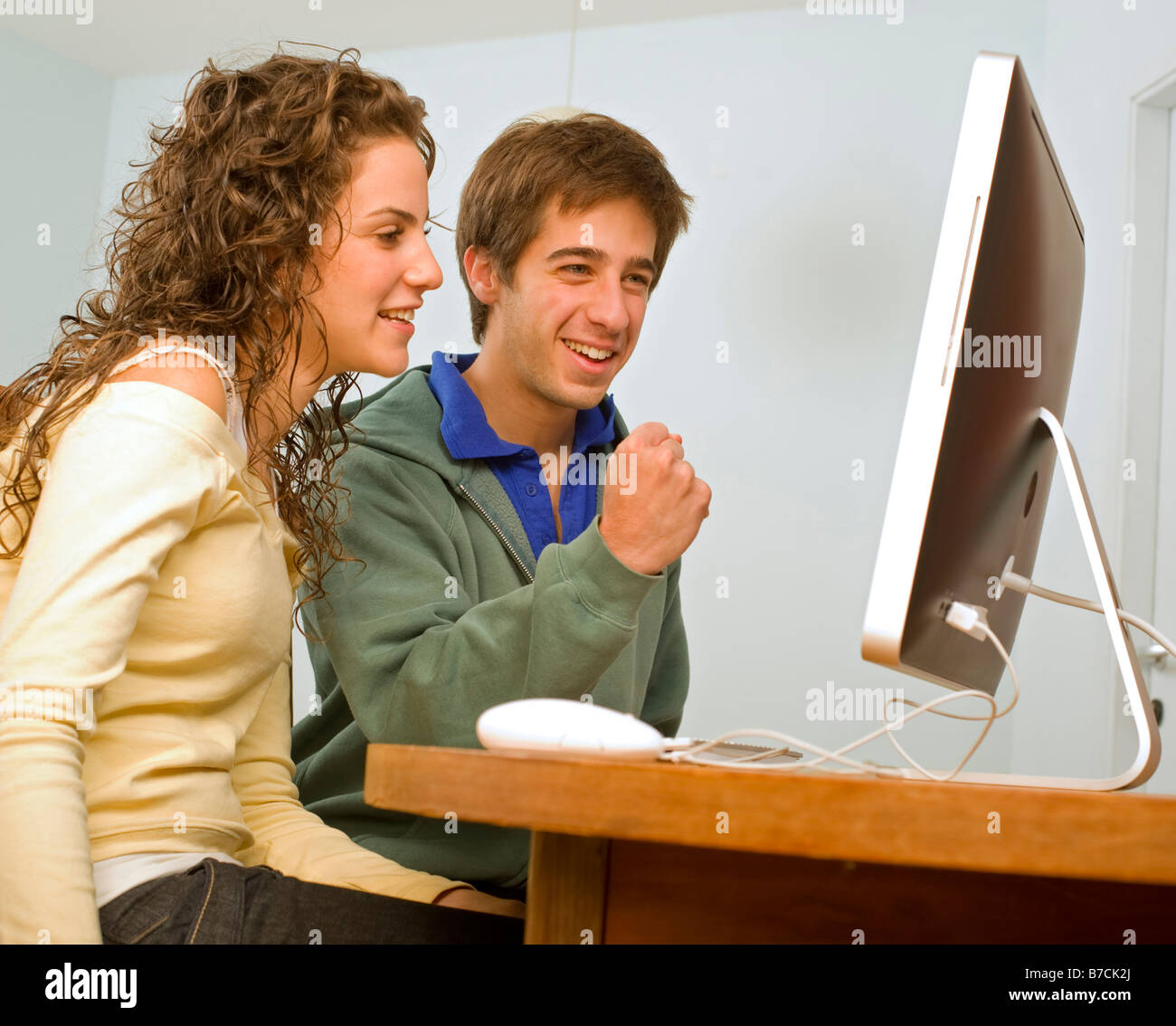 teenager couple having fun with the computer Stock Photo - Alamy