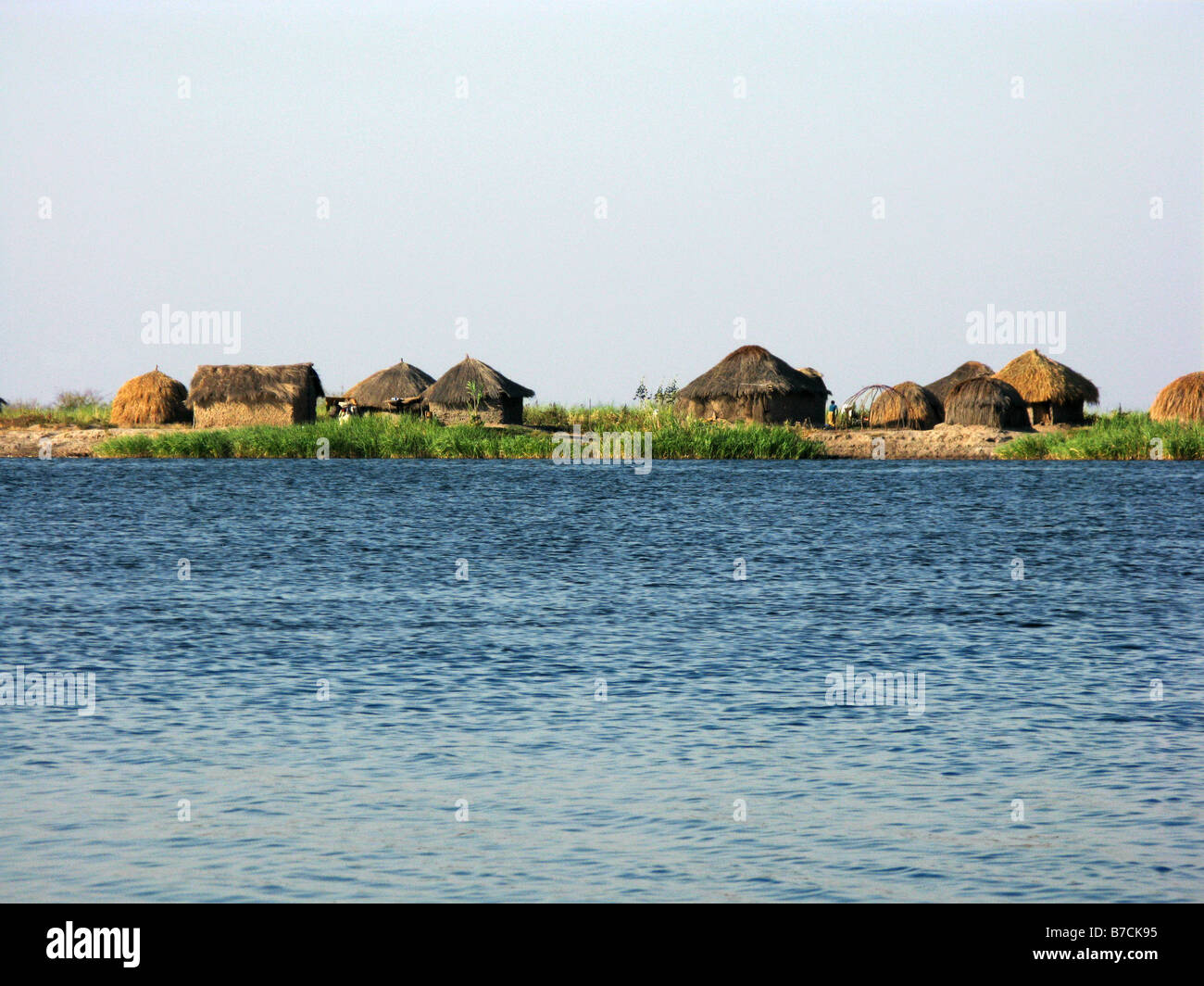 Typical straw hut village on banks of Lower Luapula River a tributary of the Congo in Democratic Republic of Congo Stock Photo