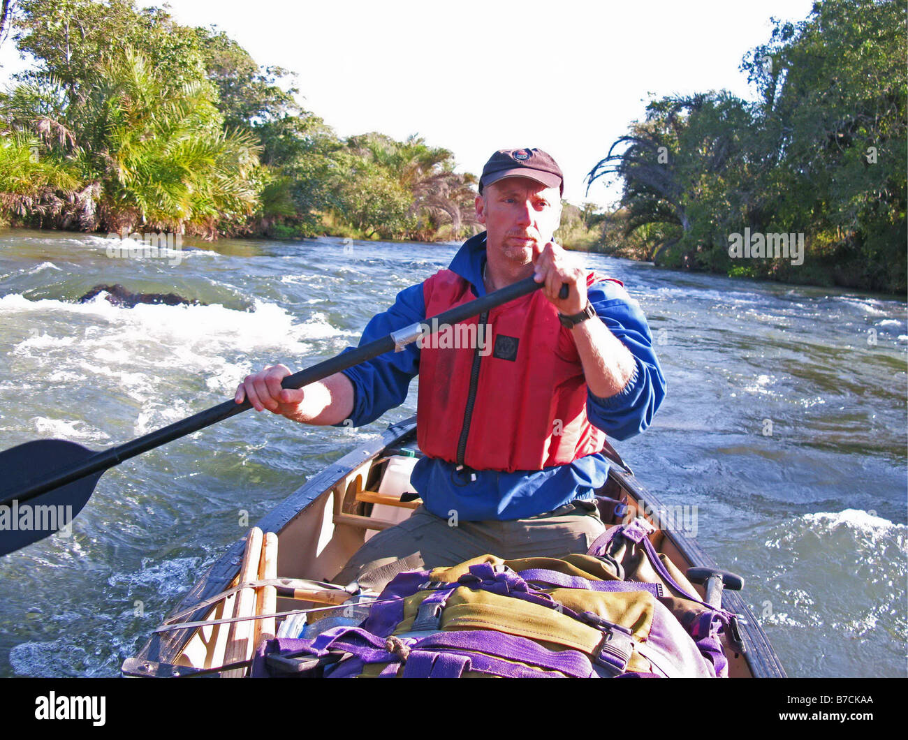 Phil Harwood canoeing on easy rapids on the Upper Chambeshi river in north east Zambia Stock Photo