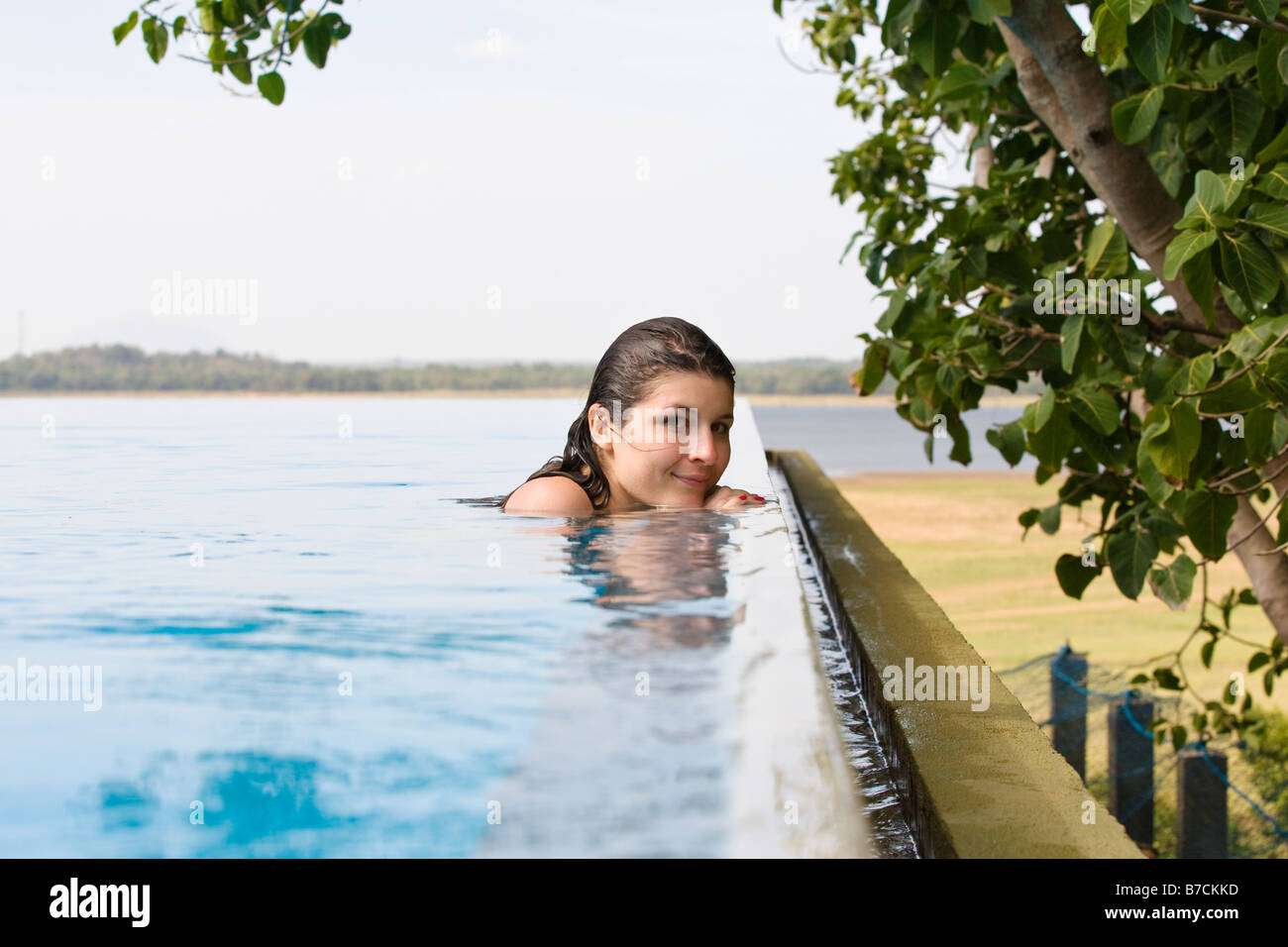 Portrait of a young woman in an infinity pool in Asia Stock Photo