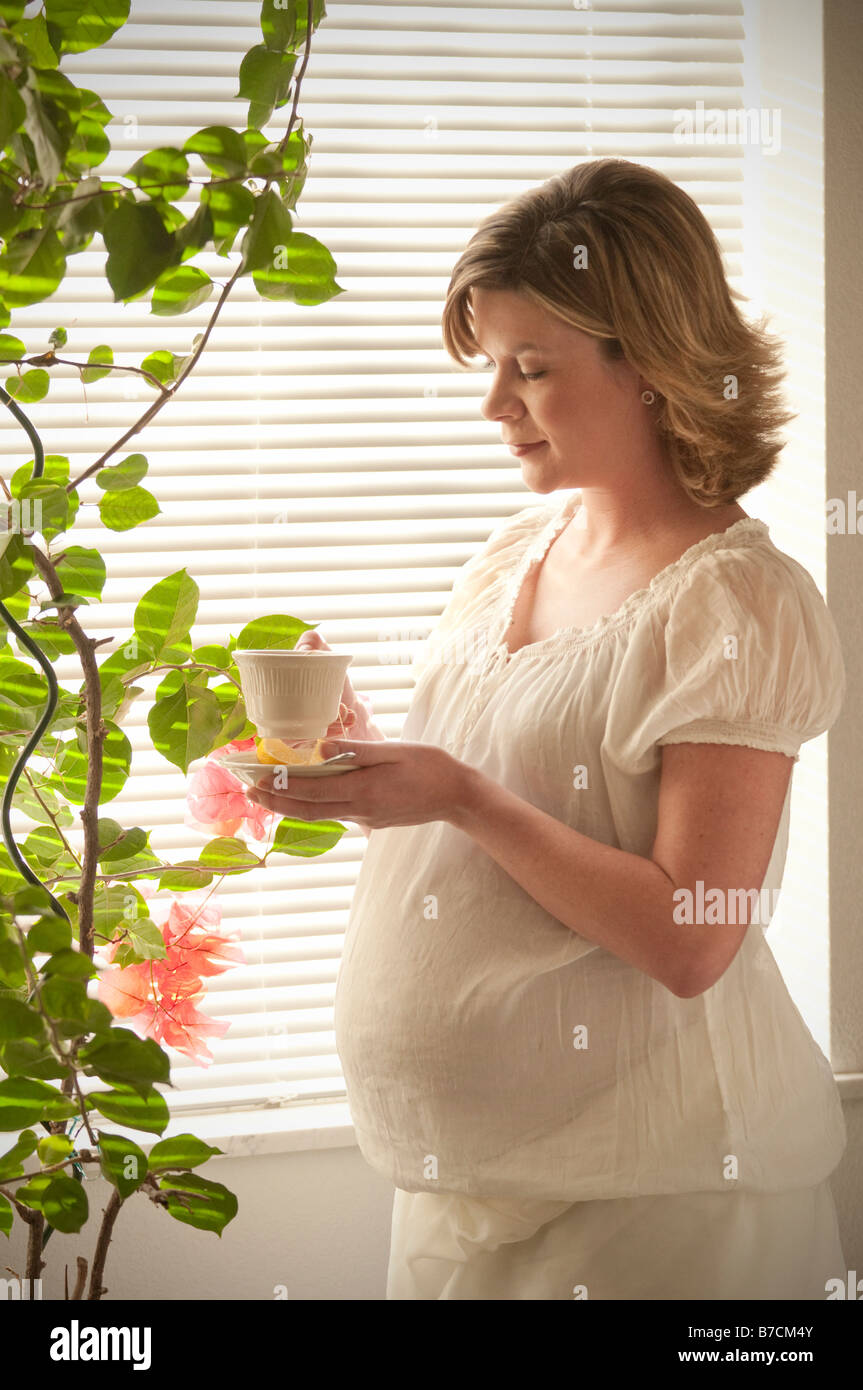 pregnant woman drinking a cup of herbal tea Stock Photo Alamy