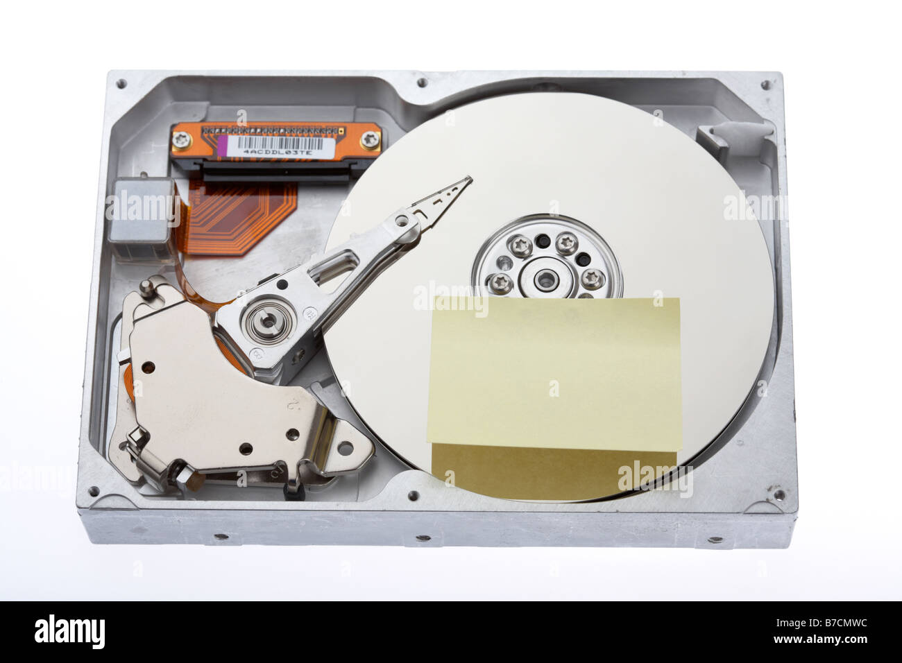 open computer hard drive with a blank sticky postit note attached on a ...