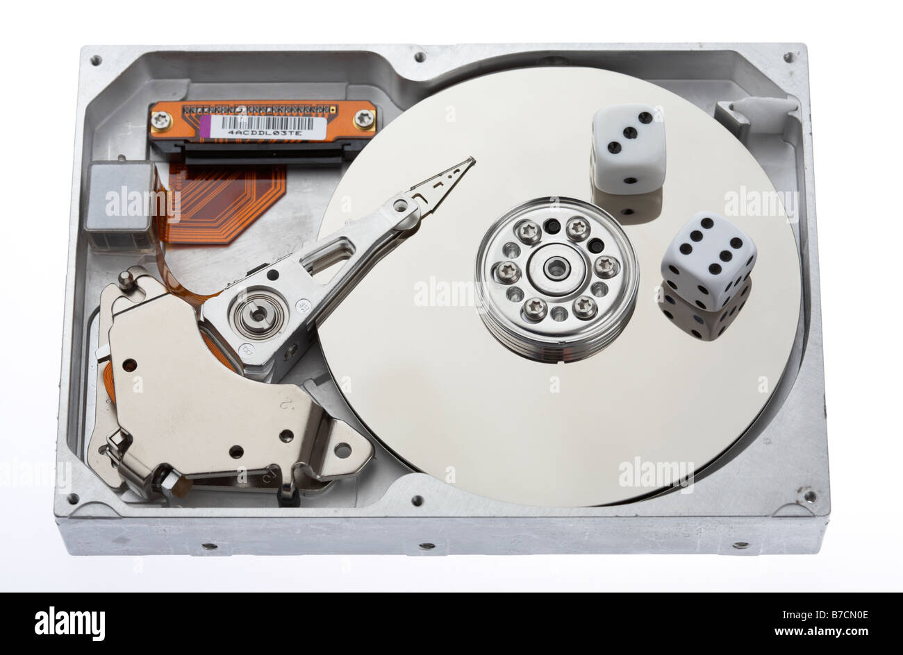 pair of dice sitting on the open platter of a computer hard drive Stock Photo