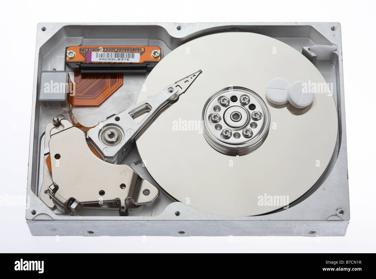 two paracetamol tablets sitting on the platter of a computer hard drive Stock Photo