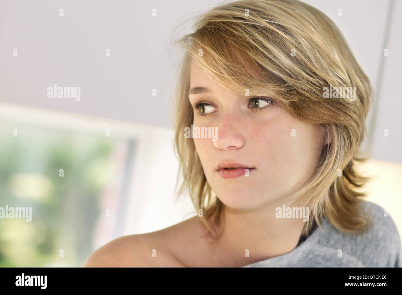 young blond woman in a pyjamas in the kitchen in the morning, Germany Stock Photo